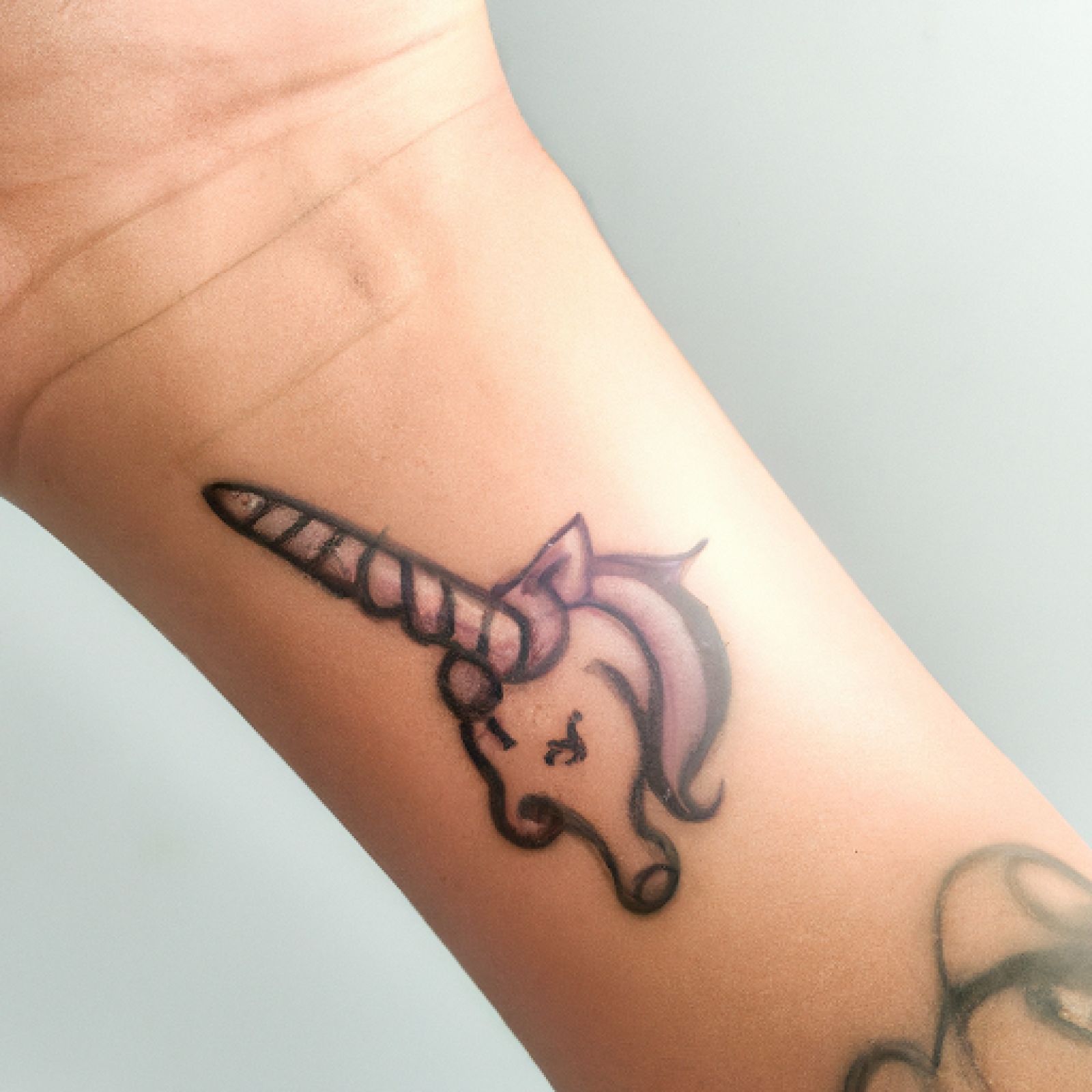Unicorn tattoo on wrist for men