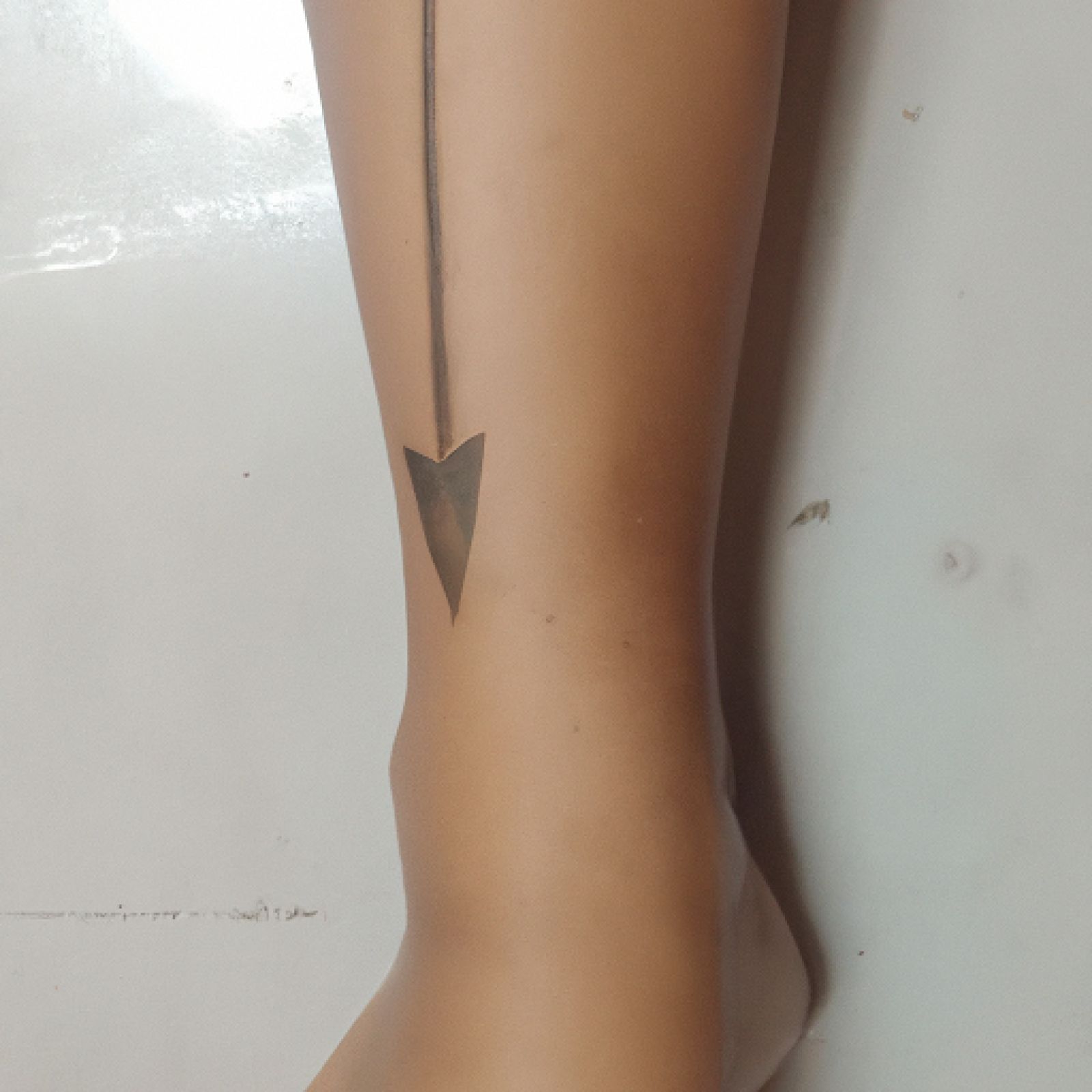 Arrow tattoo on ankle for women