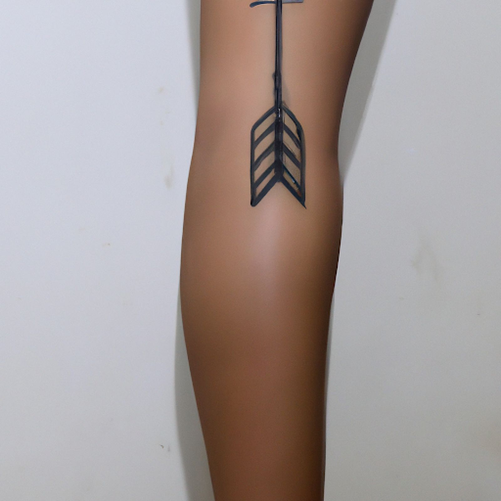 Arrow tattoo on calf for women
