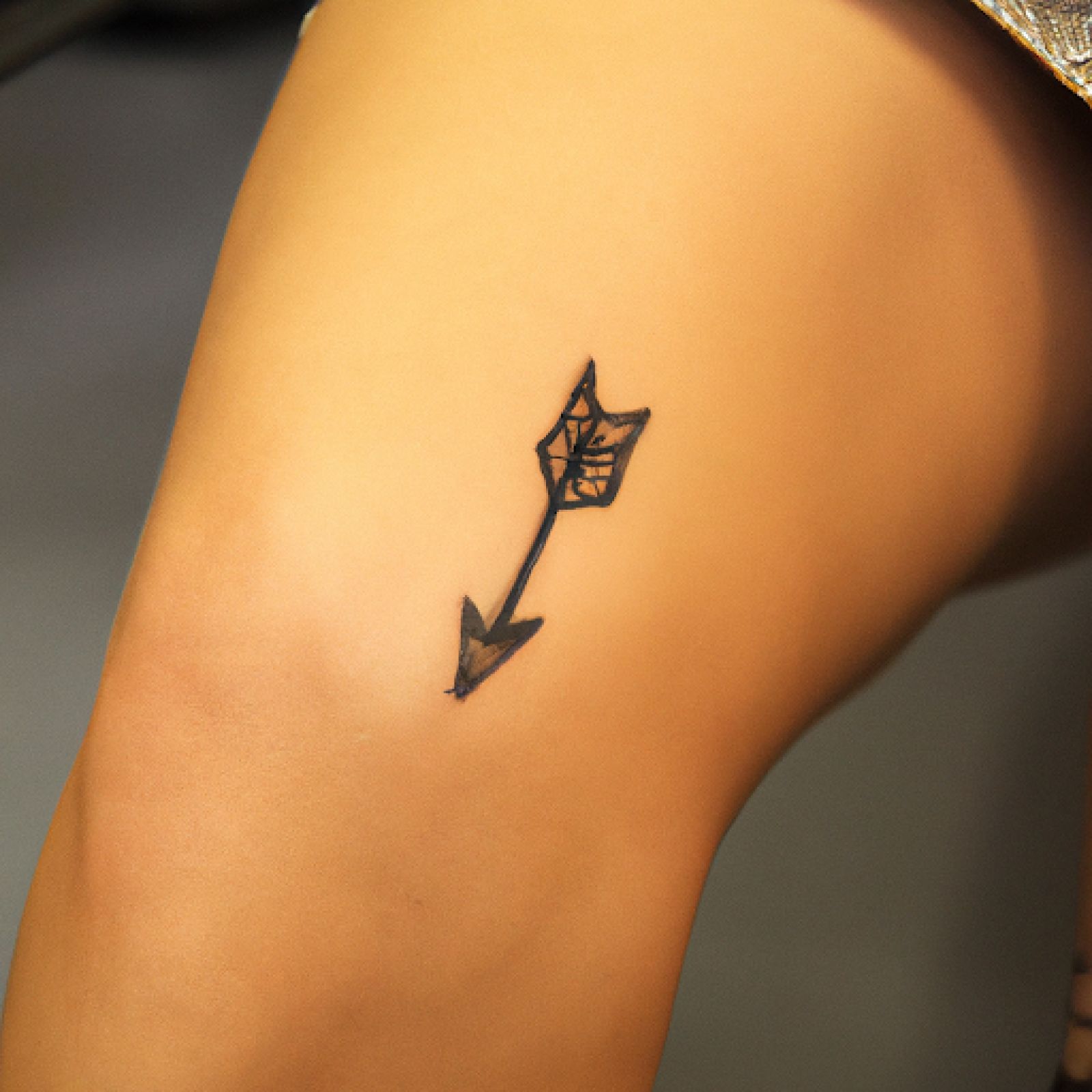 Arrow tattoo on knee for women