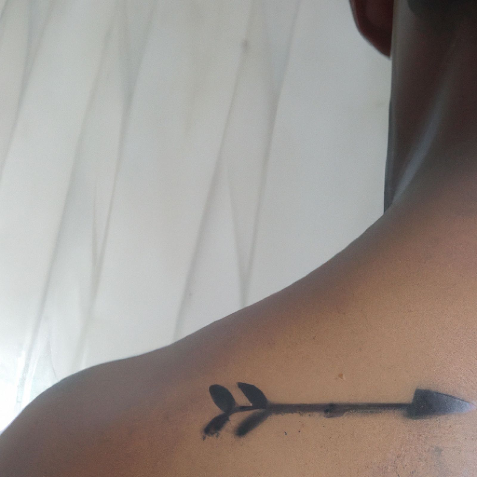 Arrow tattoo on side for men