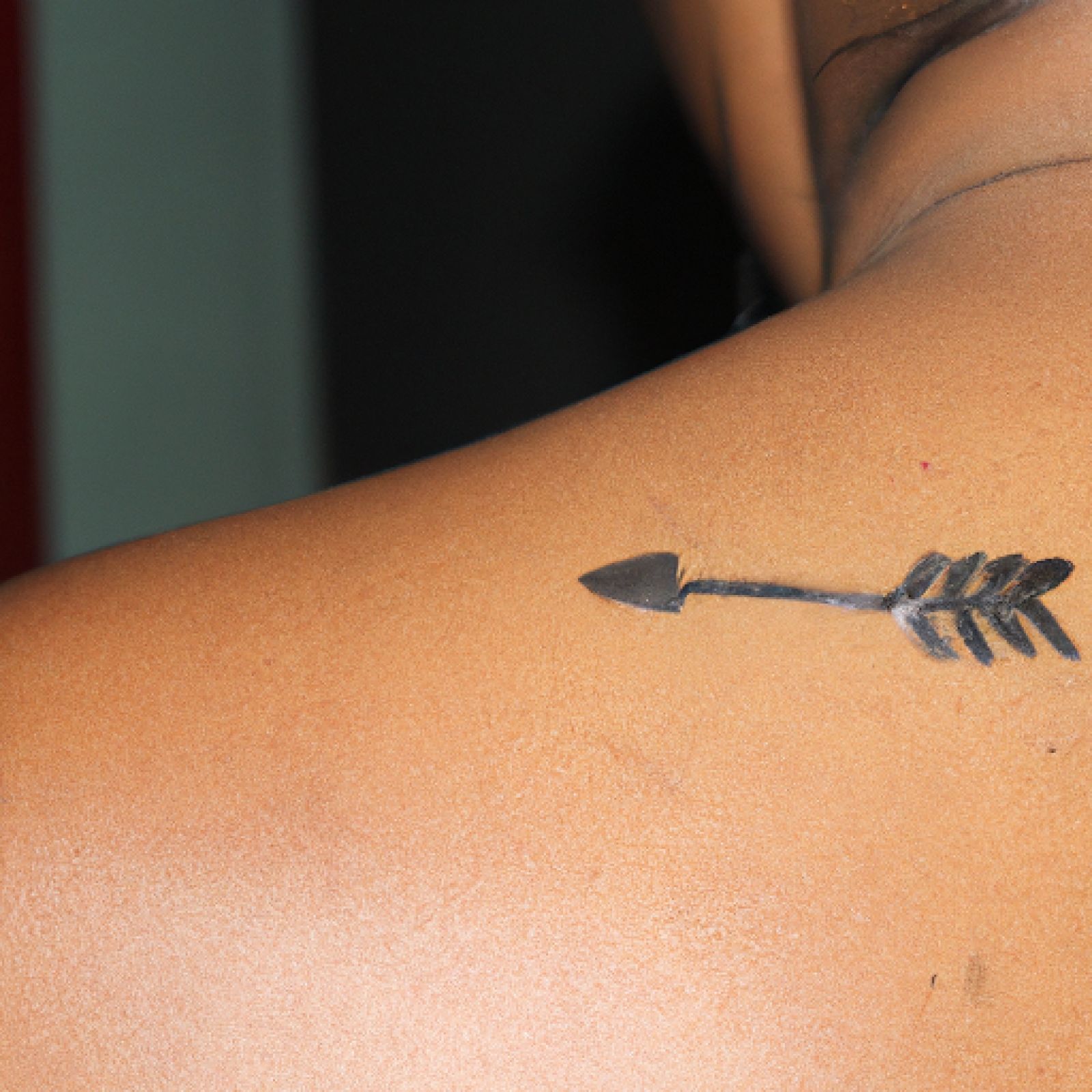 Arrow tattoo on side for women