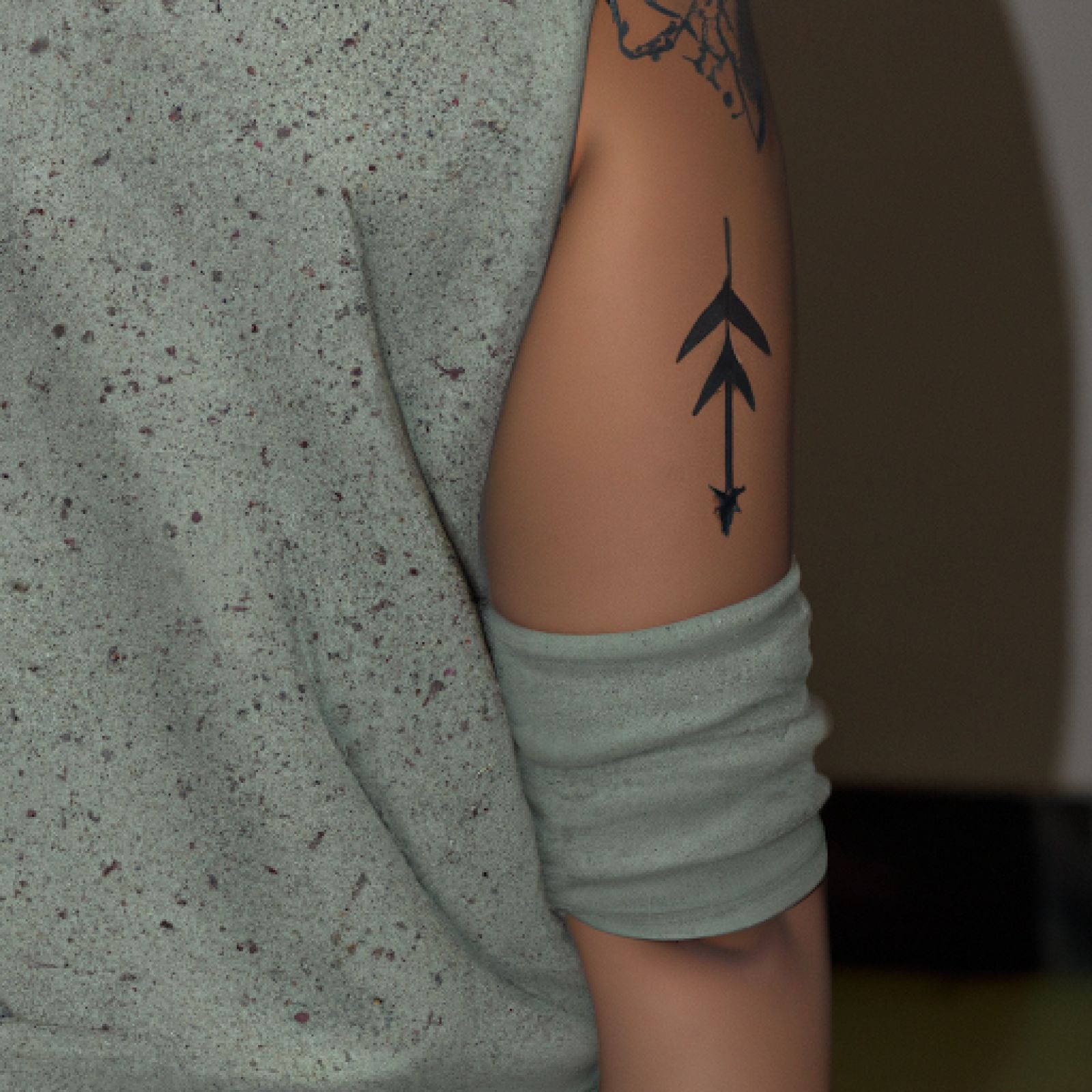 Arrow tattoo on sleeve for women