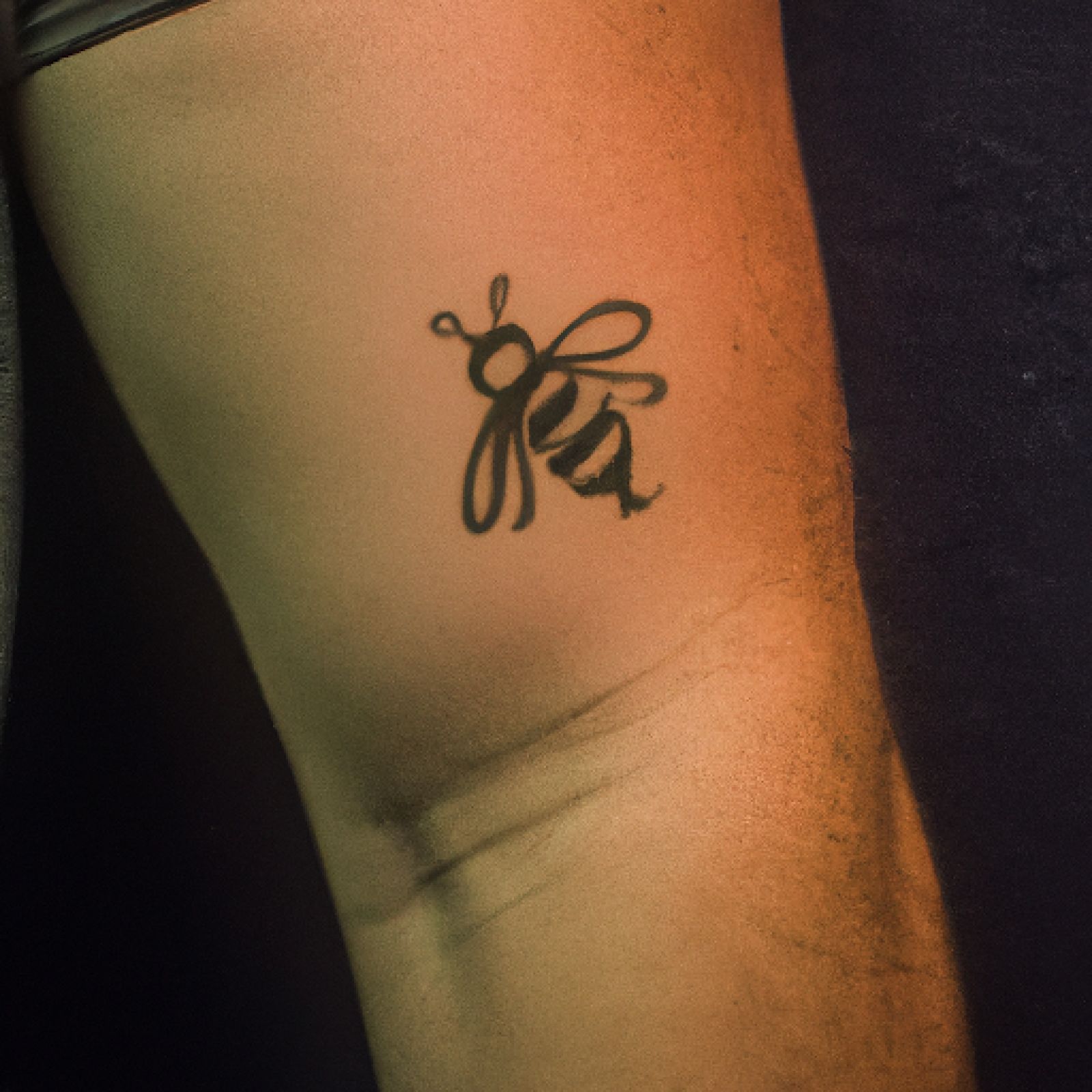 Bee tattoo on arm for men