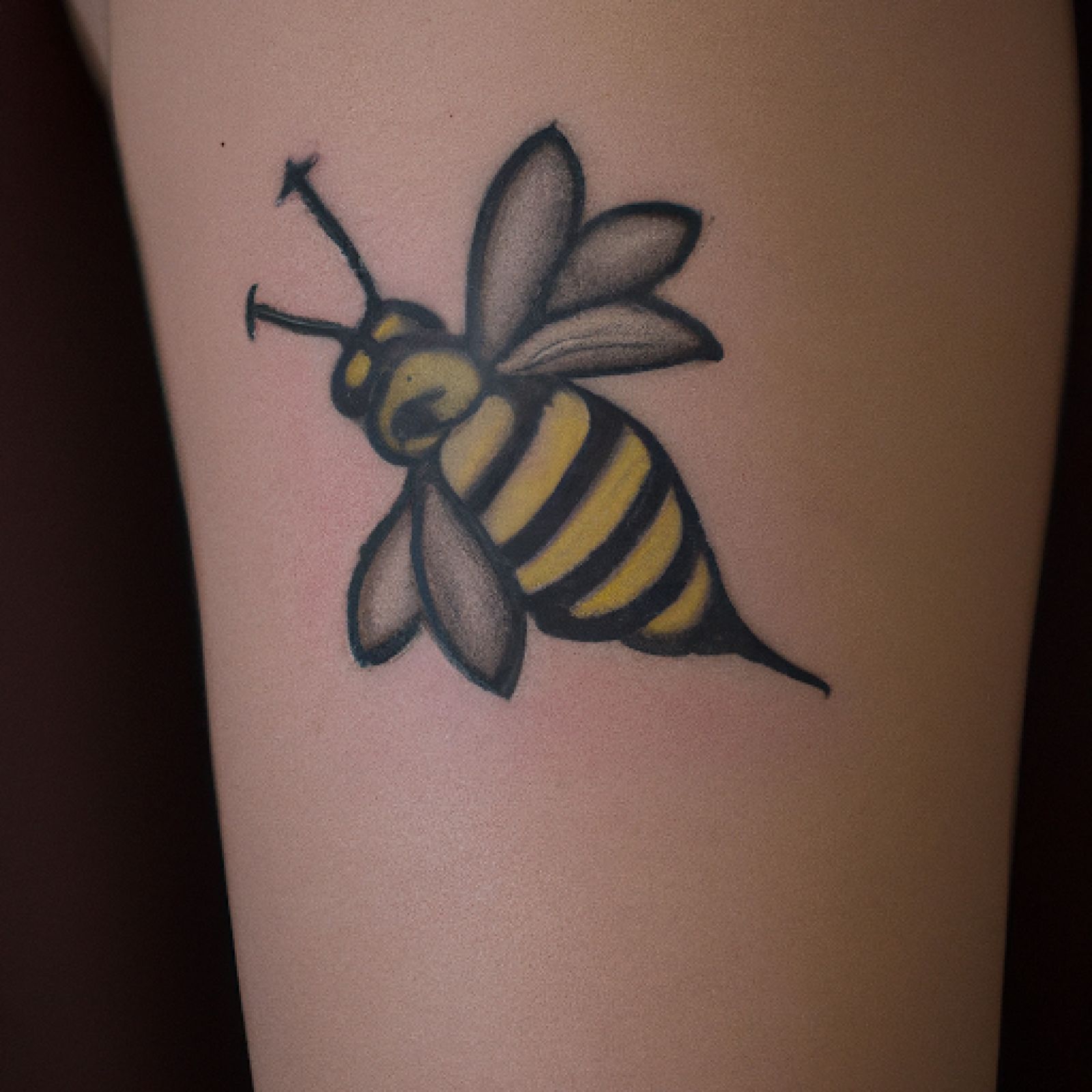 Bee tattoo on calf for women