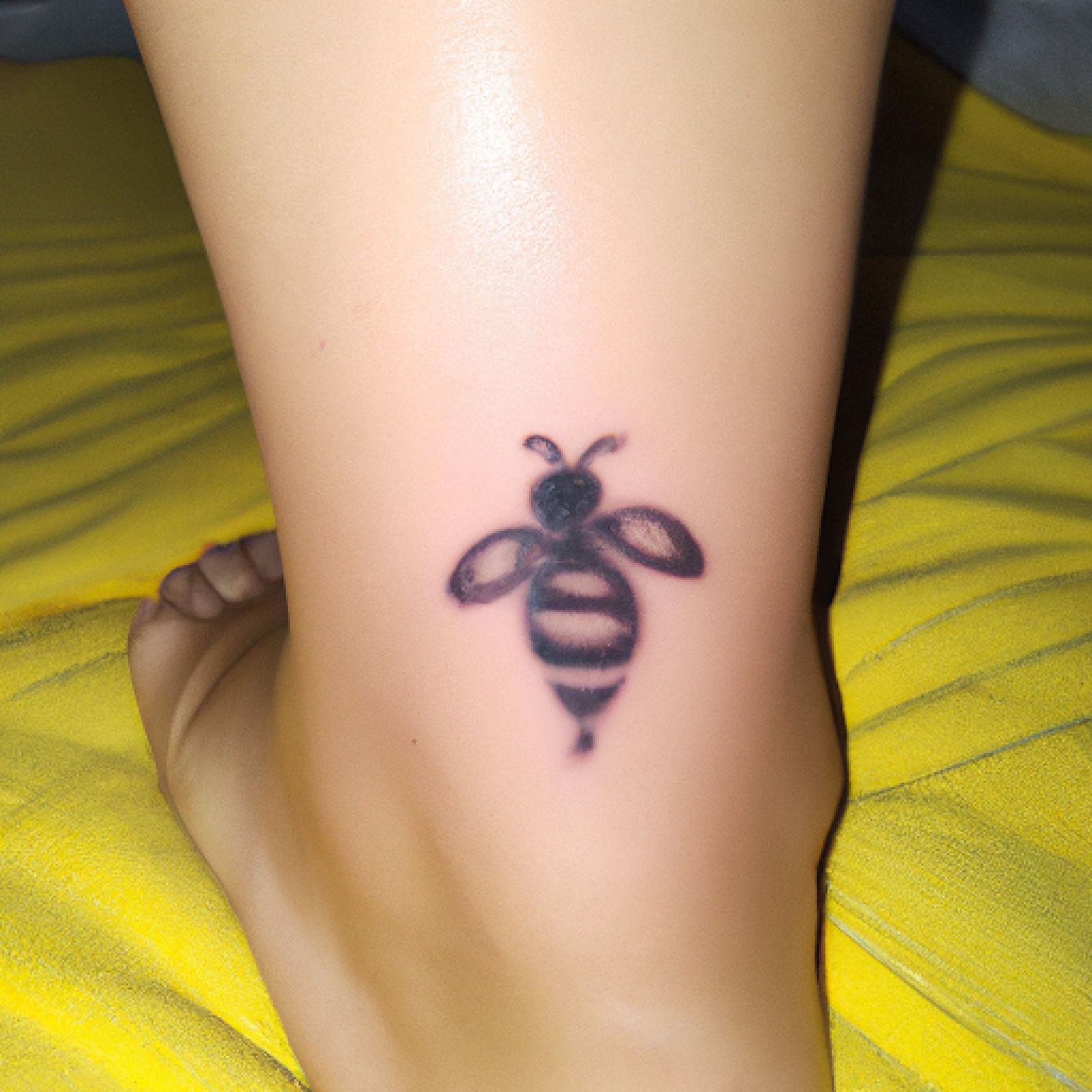 Bee tattoo on foot for women