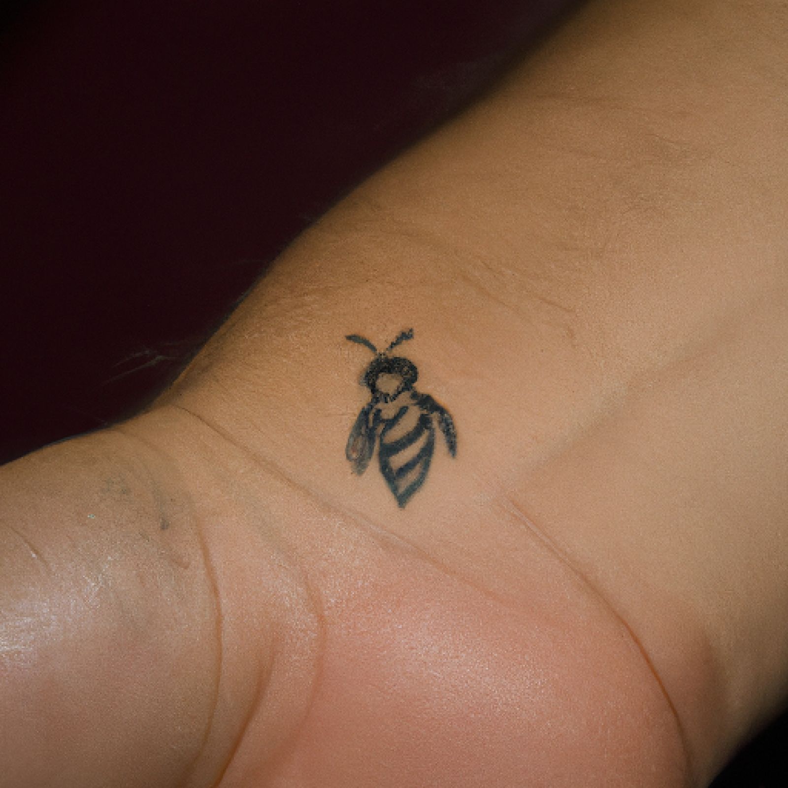 Bee tattoo on hand for men