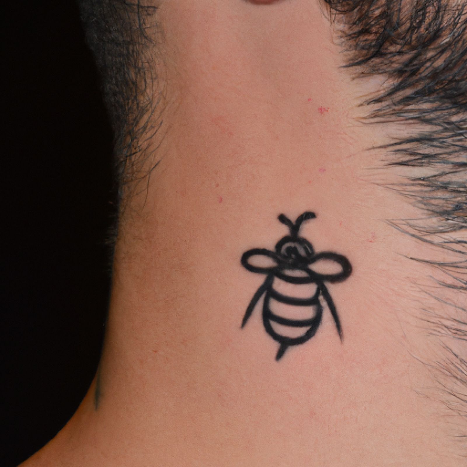 Bee tattoo on neck for men