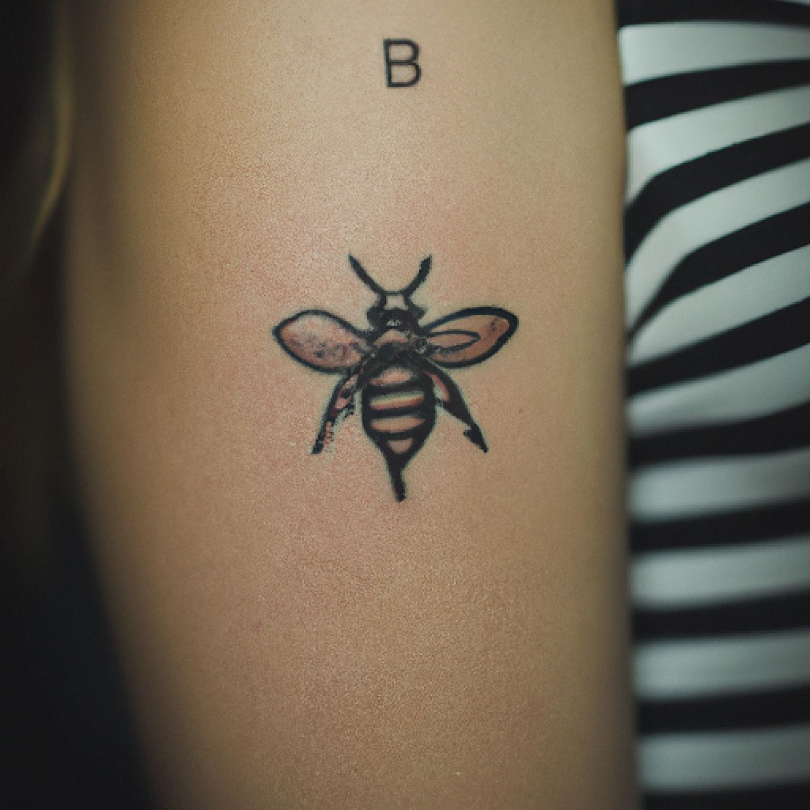 Bee tattoo on sternum for women
