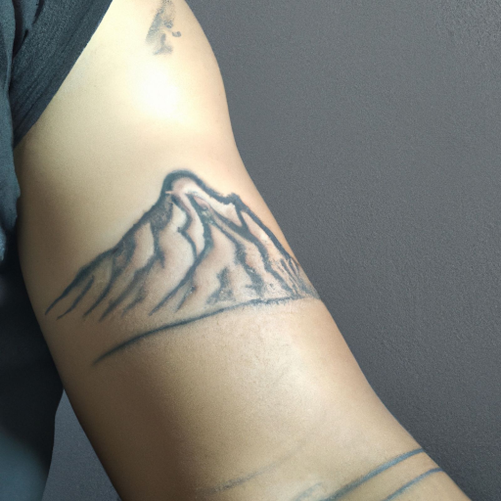 Mountain tattoo on arm for men