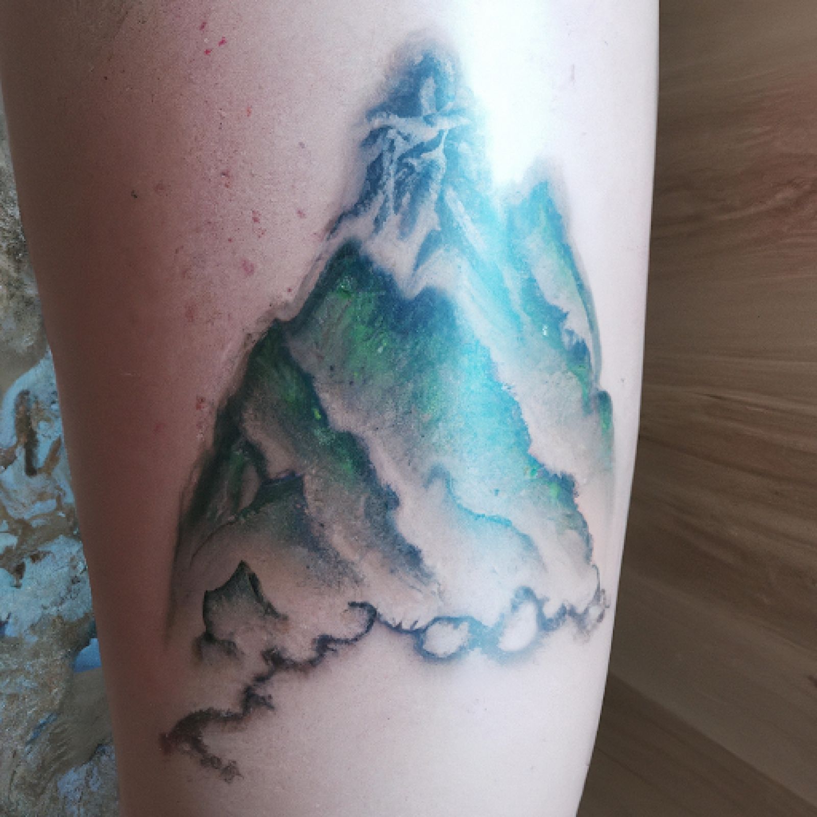 Mountain tattoo on calf for women