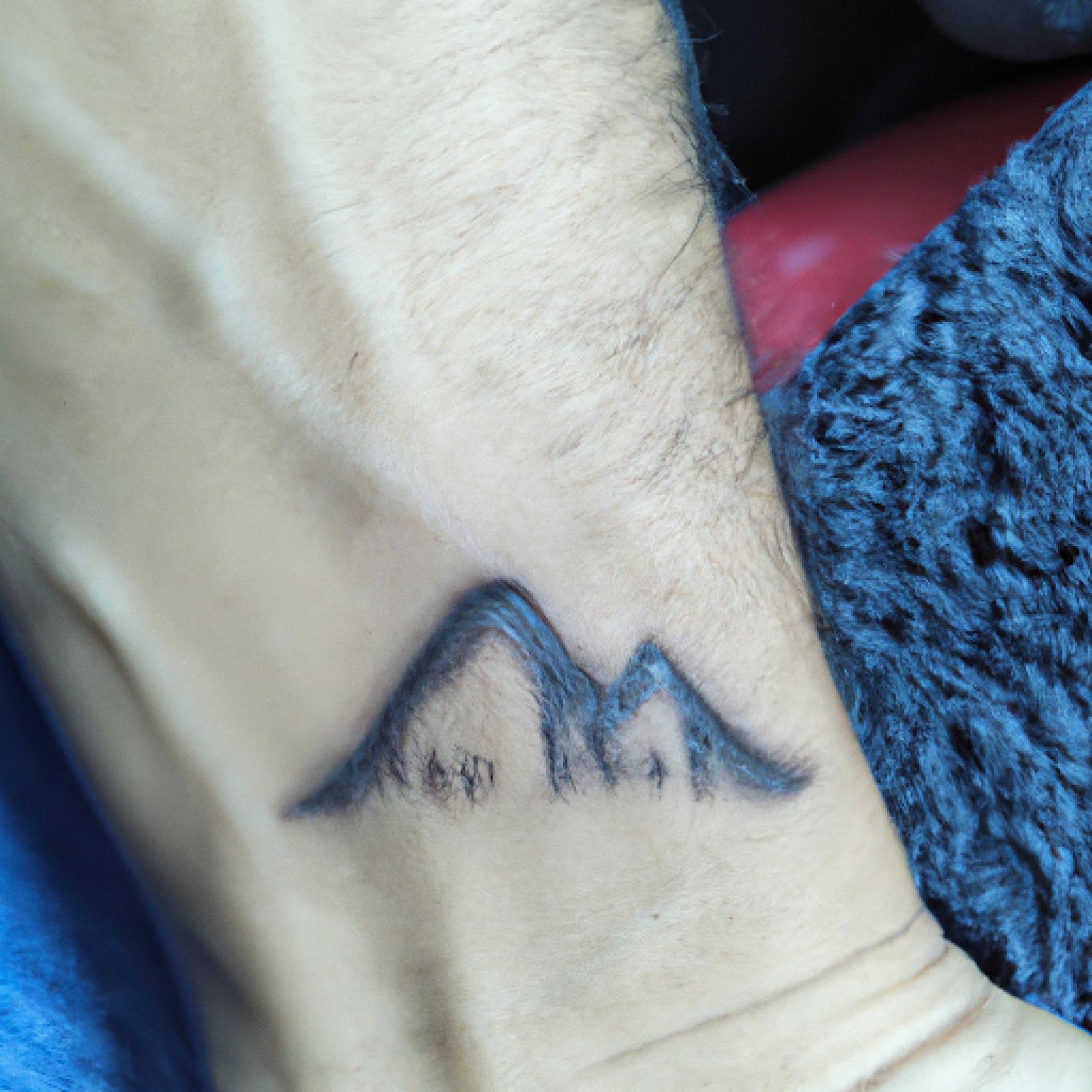 Mountain tattoo on wrist for men